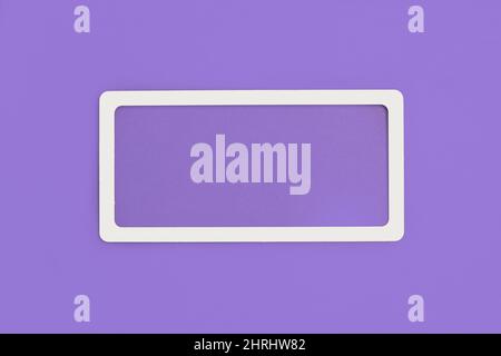 A white frame on a violet background with copy space Stock Photo