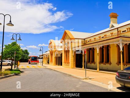Wagga Wagga city train station facade from entrance square with car park and street - historic architecture. Stock Photo