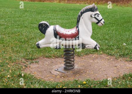 Old spring mounted playground horse. Stock Photo