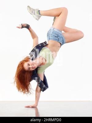 In the zone. Young woman doing hip hop dancing against a white background. Stock Photo
