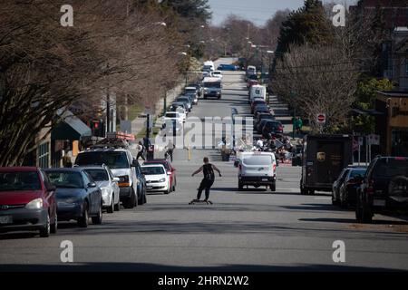 A man rides a longboard down the middle of a road, in Vancouver, on Friday, March 20, 2020. THE CANADIAN PRESS/Darryl Dyck Stock Photo