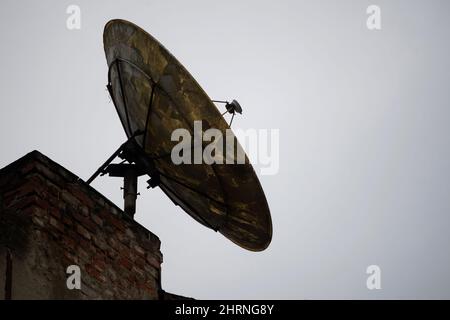 Bucharest, Romania - June 18, 2021: A satellite parabolic dish antenna is mounted on the top of a building in Bucharest. Stock Photo