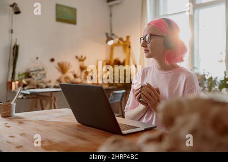 Cute female potter involved in work in her workshop Stock Photo