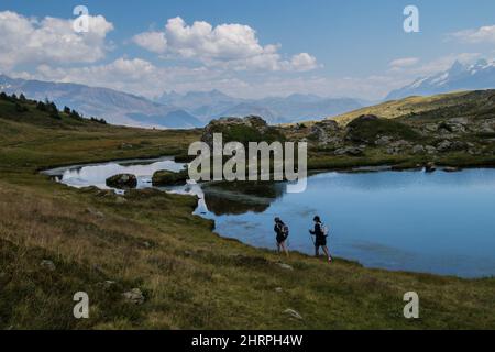 Scenic view of people hiking near a lake in Isere, France Stock Photo
