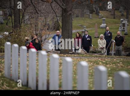 People watch the Remembrance Day ceremony from the side of the National Military Cemetery in Ottawa, on Wednesday, Nov. 11, 2020. Members of the public were encouraged to follow the ceremony from home via livestream, while a fenced off area limited attendance to comply with COVID-19 restrictions for gatherings. THE CANADIAN PRESS/Justin Tang