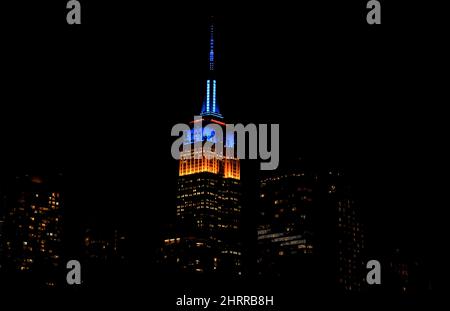New York, USA. 25th Feb, 2022. 25 February 2022 - New York City, New York, Unites States:  New York City's Empire State building is lit up in the yellow and blue colors of the Ukranian flag on Friday night, February 25. Credit: Adam Stoltman/Alamy Live News Stock Photo