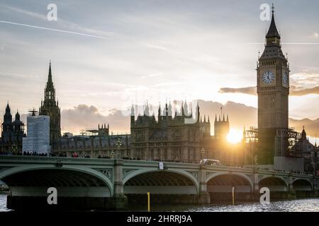 London, UK. 25th February 2022. UK Weather: Golden sunset over Westminster Bridge wih Houses of Parliament and Big Ben in view. Credit: Guy Corbishley/Alamy Live News Stock Photo