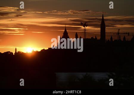 An annular solar eclipse rises behind Parliament Hill in Ottawa on Thursday, June 10, 2021. THE CANADIAN PRESS/Sean Kilpatrick Stock Photo
