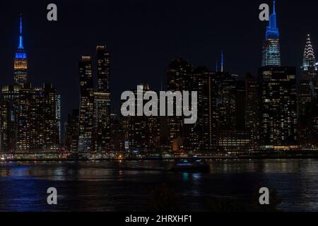 New York, USA. 25th Feb, 2022. NEW YORK, NY - FEBRUARY 25: Empire State Building, New York Times spire and One Vanderbilt are illuminated colors of Ukrainian flag on February 25, 2022 in New York City. Credit: Ron Adar/Alamy Live News Stock Photo