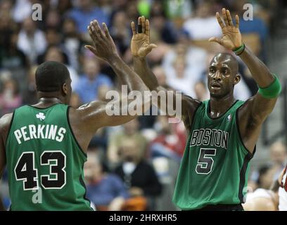 Boston Celtics forward Kevin Garnett, right, and Kendrick Perkins, left, celebrate during first-half NBA basketball game action against the Toronto Raptors on Wednesday, April 7, 2010, in Toronto. (AP Photo/The Canadian Press,Nathan Denette)