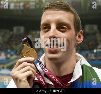 Canada's Ryan Cochrane holds up his gold medal for the men's 1500M freestyle swimming event Saturday, October 9, 2010 at the 2010 Commonwealth Games in New Delhi, India..THE CANADIAN PRESS/Ryan Remiorz