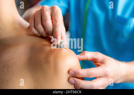 Technician placing markers on shoulder for gait analysis Stock Photo