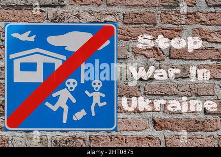 Stop War in Ukraine written on a brick wall with no bombing sign. Third world war concept Stock Photo