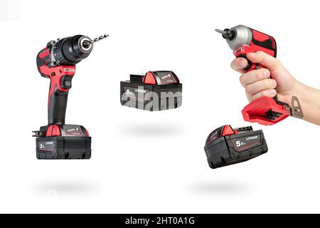cordless tool isolated on white background. Cordless screwdriver with a drill inserted into the chuck and an extra battery on a white background. Stock Photo