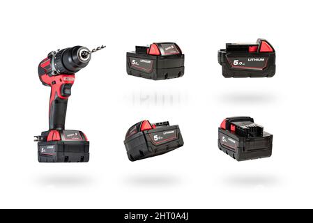 cordless tool isolated on white background. Cordless screwdriver with a drill inserted into the chuck and an extra battery on a white background. Stock Photo