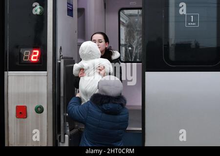 A grandmother hands over the baby to her daughter tp get to the carriage in the train for evacuation from Kramatorsk. Russian President Vladimir Putin ordered the military intervention February 24, days after recognizing two separatist-held enclaves in eastern Ukraine. He claimed that Moscow had no plan to occupy the neighboring country but wanted to “demilitarize” and “denazify” Ukraine. Ukrainian President Volodymyr Zelenskyy accused Russia of trying to install a puppet government and said Ukrainians will defend their country against Russian aggression. Stock Photo