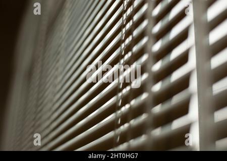 Blinds on window. White blinds cover window from sun. Interior details. Shooting diagonally. Stock Photo
