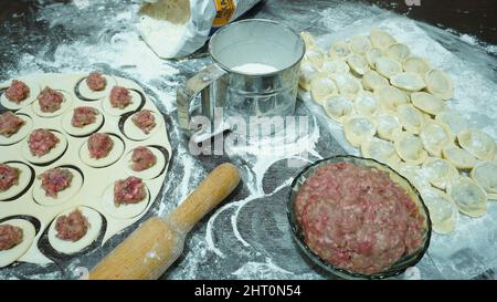 Meat dumplings - russian pelmeni on wooden background Stock Photo