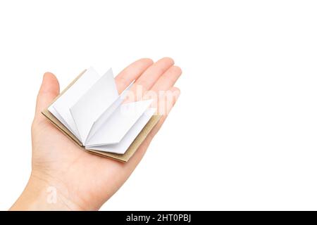 Tiny open book with blank pages in hand isolated on white background. Stock Photo