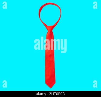Solid red necktie isolated on blue background. Stock Photo