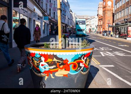 Brighton UK 26th February 2022 - Newly placed giant flower pots in North Street Brighton are lit up by the sunshine on a sunny but chilly morning in the South of Britain  : Credit Simon Dack / Alamy Live News Stock Photo