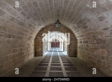 tunnel corridor with bars at the end light at the end of the tunnel Stock Photo