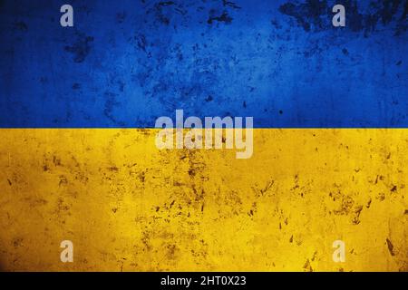Grungy and damaged wall painted with blue and yellow paint like Ukrainian flag Stock Photo