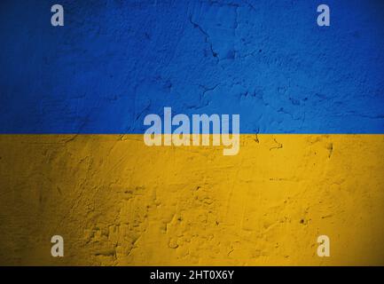 Grungy and damaged wall painted with blue and yellow paint like  Ukrainian flag Stock Photo