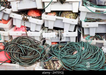 Fish boxes, ropes and fishing floats used by fishermen as equipment on their trawlers. Stock Photo