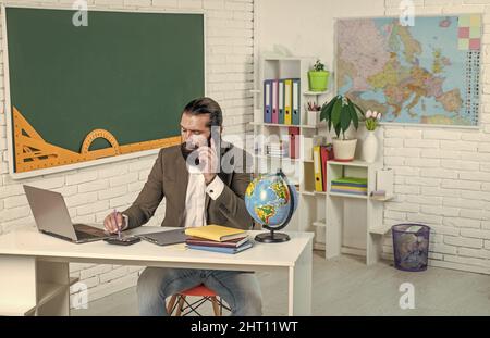 formal education. knowledge day. mature bearded teacher at lesson. brutal man work in classroom with blackboard. prepare for exam. college lecturer on Stock Photo
