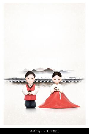 Korean traditional holiday culture where couples in hanbok, wishing happiness and greeting the new year against the backdrop of a tiled house and a fe Stock Photo