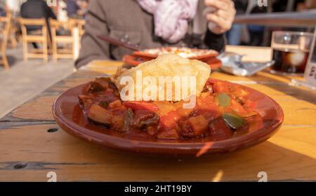 Vegetable pistou with a piece of cod. Served in a clay plate. Spanish cuisine concept. Stock Photo