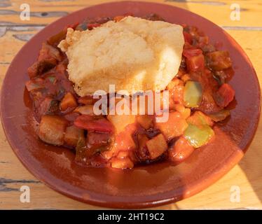 Vegetable pistou with a piece of cod. Served in a clay plate. Spanish cuisine concept. Stock Photo