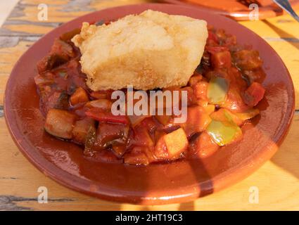 Vegetable pistou with a piece of cod. Served in a clay plate. Spanish cuisine concept. Stock Photo