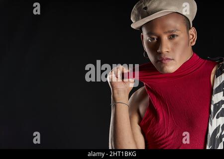 Studio portrait of a latin man with beret on black background Stock Photo