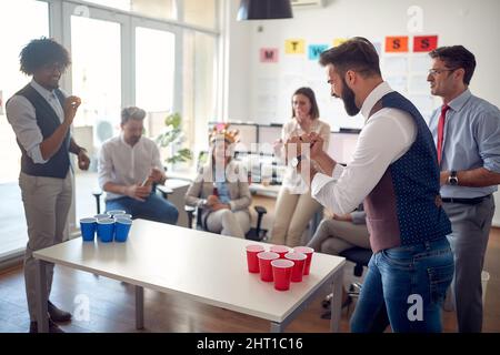 Group of diverse casual corporate coworkers having fun in the office Stock Photo