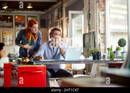 Young employees cooperation together at work in the office Stock Photo