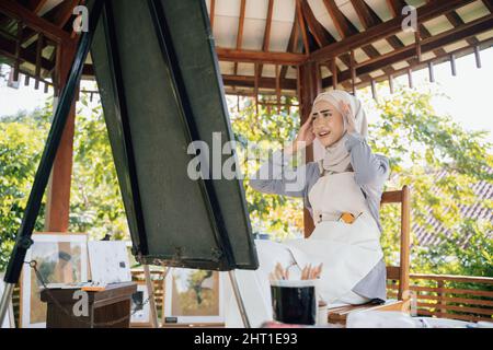 muslim female thinking while working in her project at studio Stock Photo