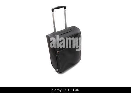 A black trolley bag. Isolated on white background. Vacation concept. Stock Photo