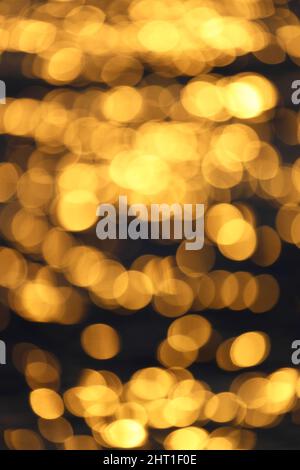 Abstract nature summer ocean sunset sea background. Small waves on water surface in motion blur with bokeh lights from sunrise. Holiday, vacation and Stock Photo
