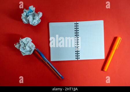 Blank open notebook and pen isolated on red background. Top view, flat lay. Stock Photo