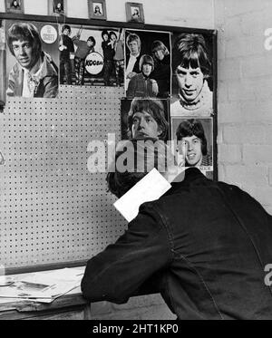 Pop stars look down from the cell wall as an inmate writes home at Hindley Borstal, Greater Manchester. 10th June 1966. Stock Photo