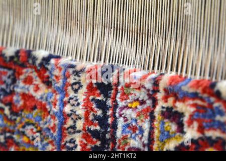 Erbil, Iraq - March 26, 2018: Handmade rug, colorful patterns, main threads, Iraq. Stock Photo