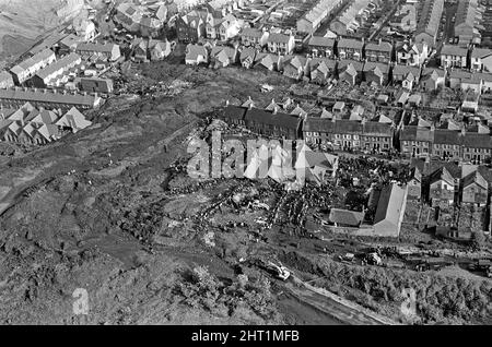 Aberfan - 21st October 1966 Aerial picture, taken from a plane, shows the town of Aberfan below, the mud slide, and how the mud as destroyed the school and houses in the town below. Lines of people queue to help the rescue effort.  The Aberfan disaster was a catastrophic collapse of a colliery spoil tip in the Welsh village of Aberfan, near Merthyr Tydfil. It was caused by a build-up of water in the accumulated rock and shale, which suddenly started to slide downhill in the form of slurry and engulfed The Pantglas Junior School below, on 21st October 1966, killing 116 children and 28 adults. Stock Photo