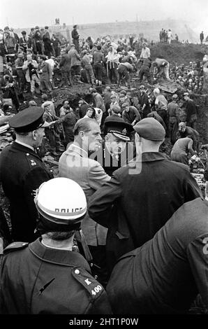 Aberfan, South Wales, 22nd October 1966The Duke of Edinburgh visits Aberfan, and is seen here at the site of The Pantglas Junior School, talking with locals as the reuse and recovery effort goes on. 22nd October,  the day after the 21st October disaster. The Aberfan disaster was a catastrophic collapse of a colliery spoil tip in the Welsh village of Aberfan, near Merthyr Tydfil. It was caused by a build-up of water in the accumulated rock and shale, which suddenly started to slide downhill in the form of slurry and engulfed The Pantglas Junior School below, on 21st October 1966, killing 116 ch Stock Photo