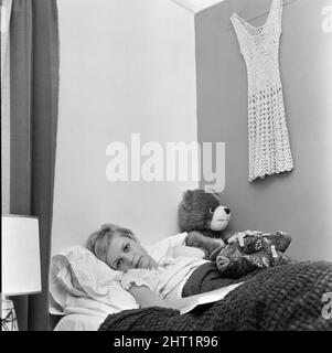 Twiggy, model aged 17 years old, was to be a guest of honour at Women of the Year luncheon at the Savoy Hotel, but was instead confined to bed, on doctors orders, because of a nervous rash on her hands and feet, pictured at home in Neasden, London, 10th October 1966. Stock Photo