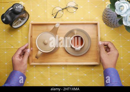 top view of green tea, clock on a table  Stock Photo