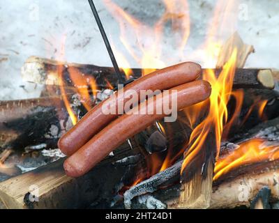 Sausages are grilled over an open fire Stock Photo