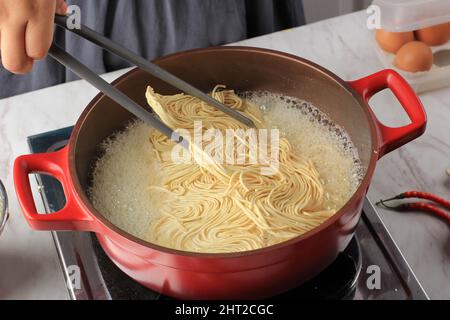 Close Up In the Making of Asian Japanese Noodle, Boiling Dry Noodle, Egg Noodle Mie Telor