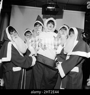 Christmas preparations for Ready Steady Go! at Rediffusion  - British rock group The Animals with television presenter Cathy McGowan dressed in Father Christmas outfits.1st December 1965. Stock Photo